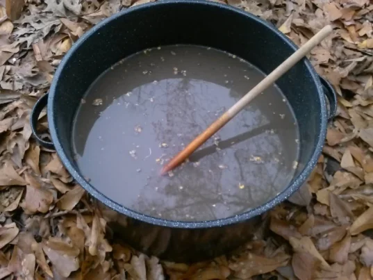 metal pot with ash mixture & dry corn