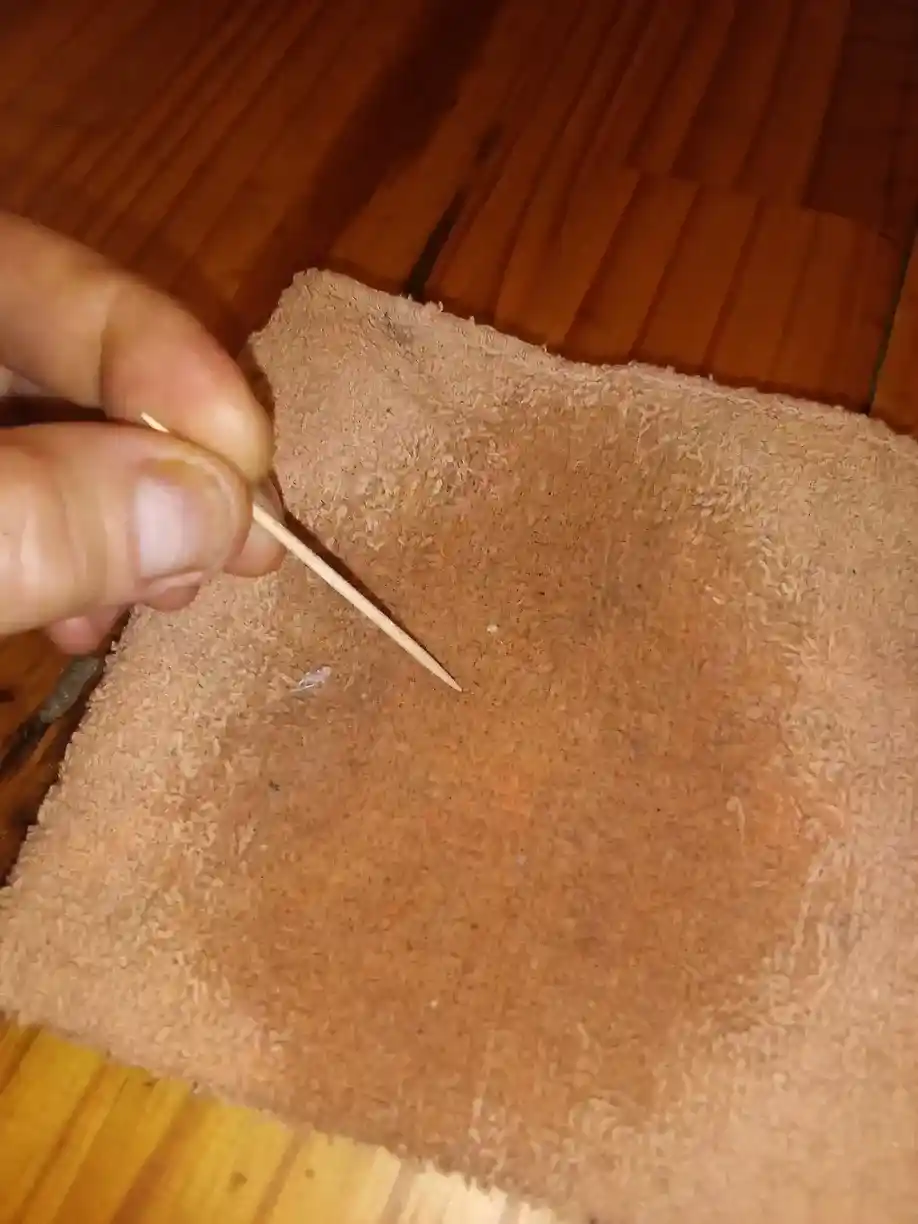 Touching tip of toothpick to a damp rag