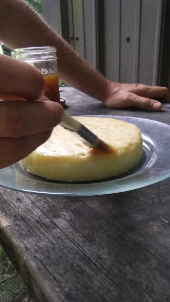 painting wax on cheese wheel