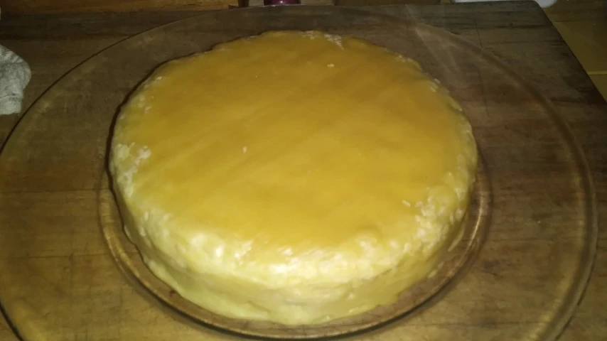waxed cheese wheel on plate